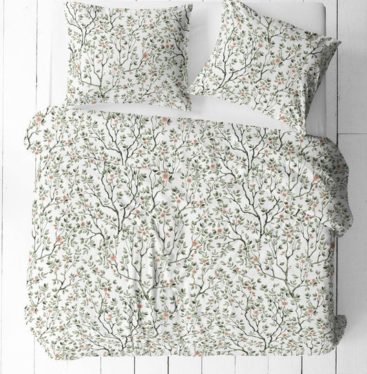 Image of 100% cotton fabric with delicate green branches and flowers on a white background – available online at Šarlotes audumi