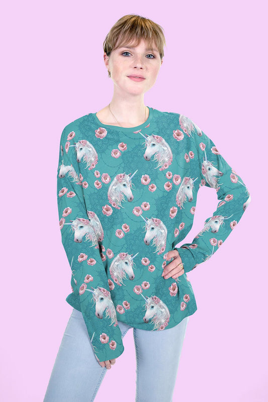 Image of unicorns on mint cotton loopback knit – available online at Charlotte's Fabrics