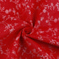 Attēls ar 100% Kokvilnas audums - baltas ziedošas stīgas uz sarkana 125 g/m² – pieejams Šarlotes audumi