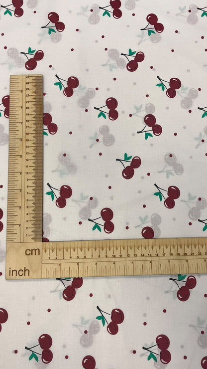 Image of 100% cotton fabric with cherries – available online at Charlotte Fabrics