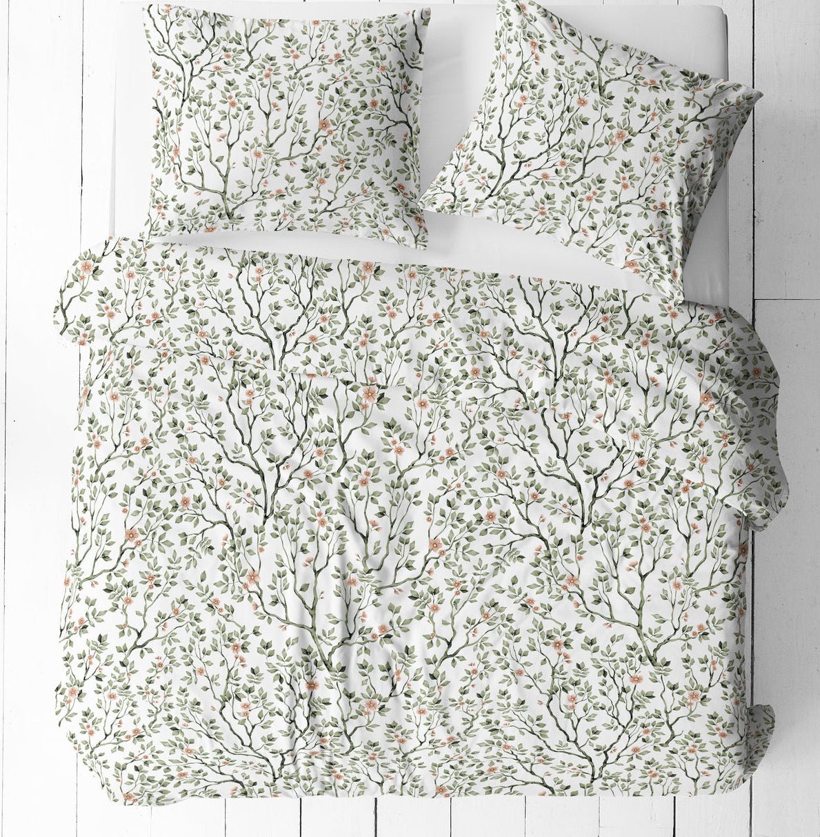 Image of 100% cotton fabric with delicate green branches and flowers on a white background – available online at Šarlotes audumi
