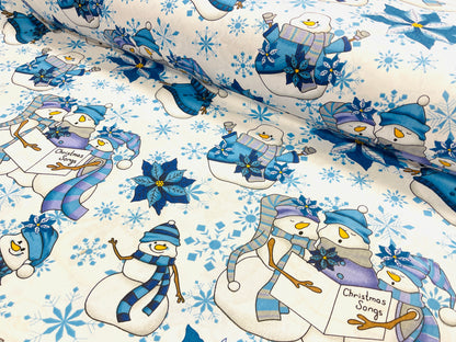 Tissu 100 % coton - bonhomme de neige avec chapeau bleu sur fond blanc 130 g/m²