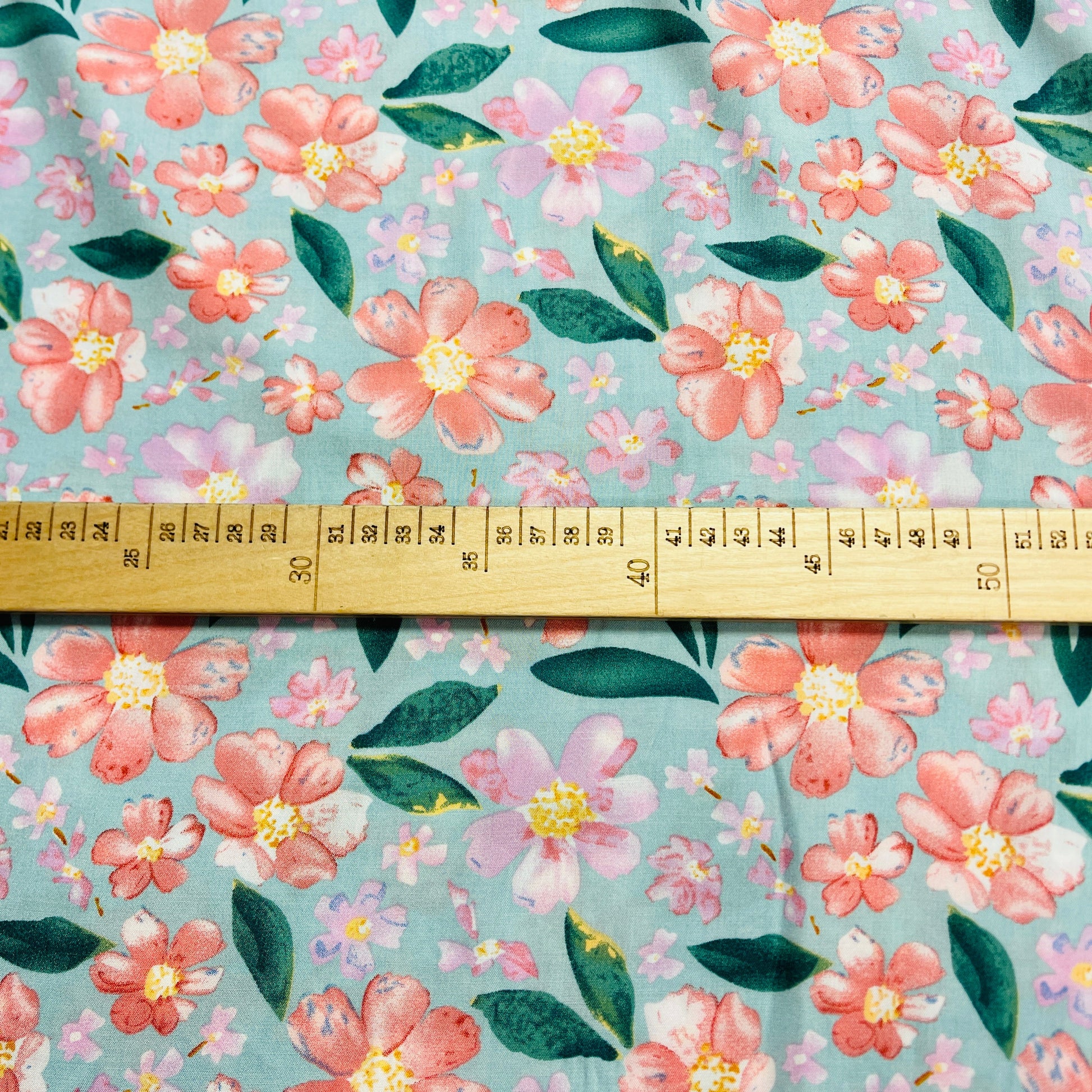 Attēls ar 100% Viskozes audums - puķes uz mint fona 135 g/m² – pieejams Šarlotes audumi