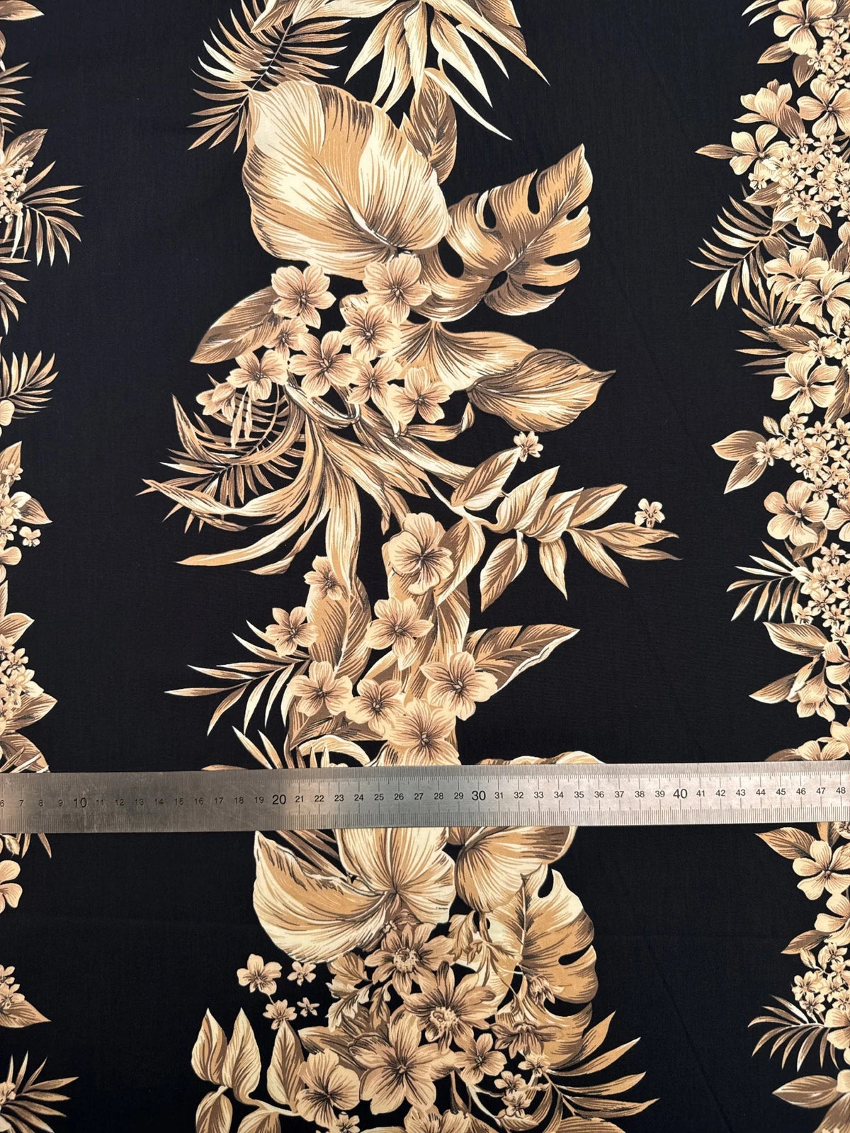 Image of Italian cotton fabric with a tropical floral pattern on a black background – available online Charlotte Fabrics