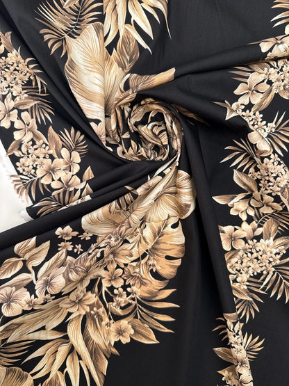 Image of Italian cotton fabric with a tropical floral pattern on a black background – available online at Šarlotes audumi