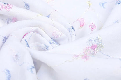 Tissu en coton brodé - broderie colorée 110 g/m²