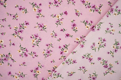 Image of thin crepe fabric with pink flowers – available online at Charlotte's Fabrics