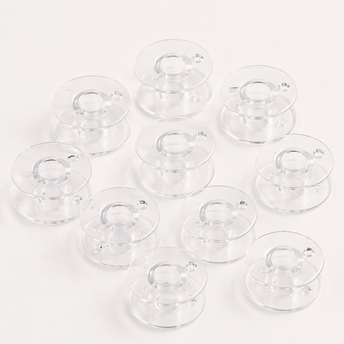 Attēls ar Plastmasas spolīte plakana šujmašīnām Ø 20,4 mm-komplekts 10 gab. – pieejams internetā Šarlotes audumi