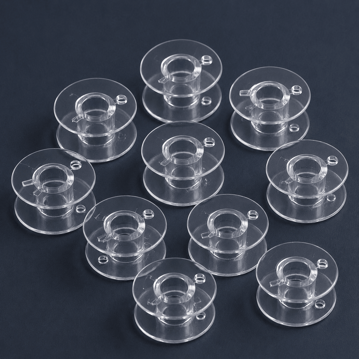 Attēls ar Plastmasas spolīte plakana šujmašīnām Ø 20,4 mm-komplekts 10 gab. – pieejams internetā Šarlotes audumi