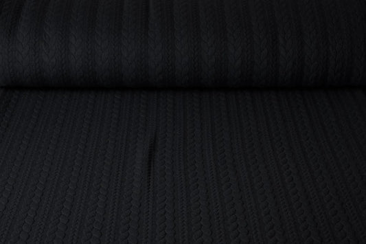 Attēls ar Trikotāžas audums ar adījuma rakstu - melnas pīnes 340 g/m² – pieejams Šarlotes audumi