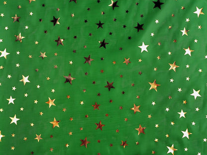 Image of Christmas fabric with gold stars on green – available online at Charlotte's Fabrics