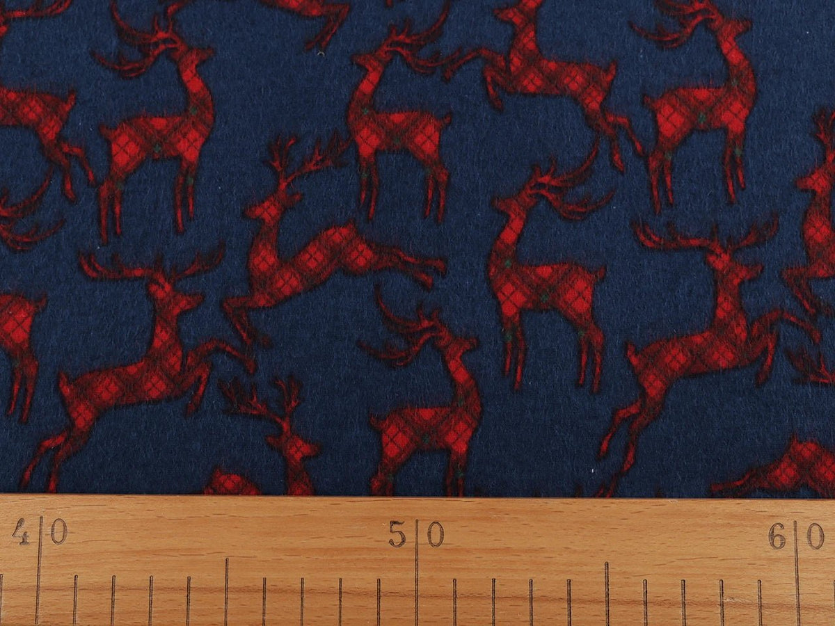 Christmas cotton flannel with reindeer on blue - available online at Charlotte's Fabrics